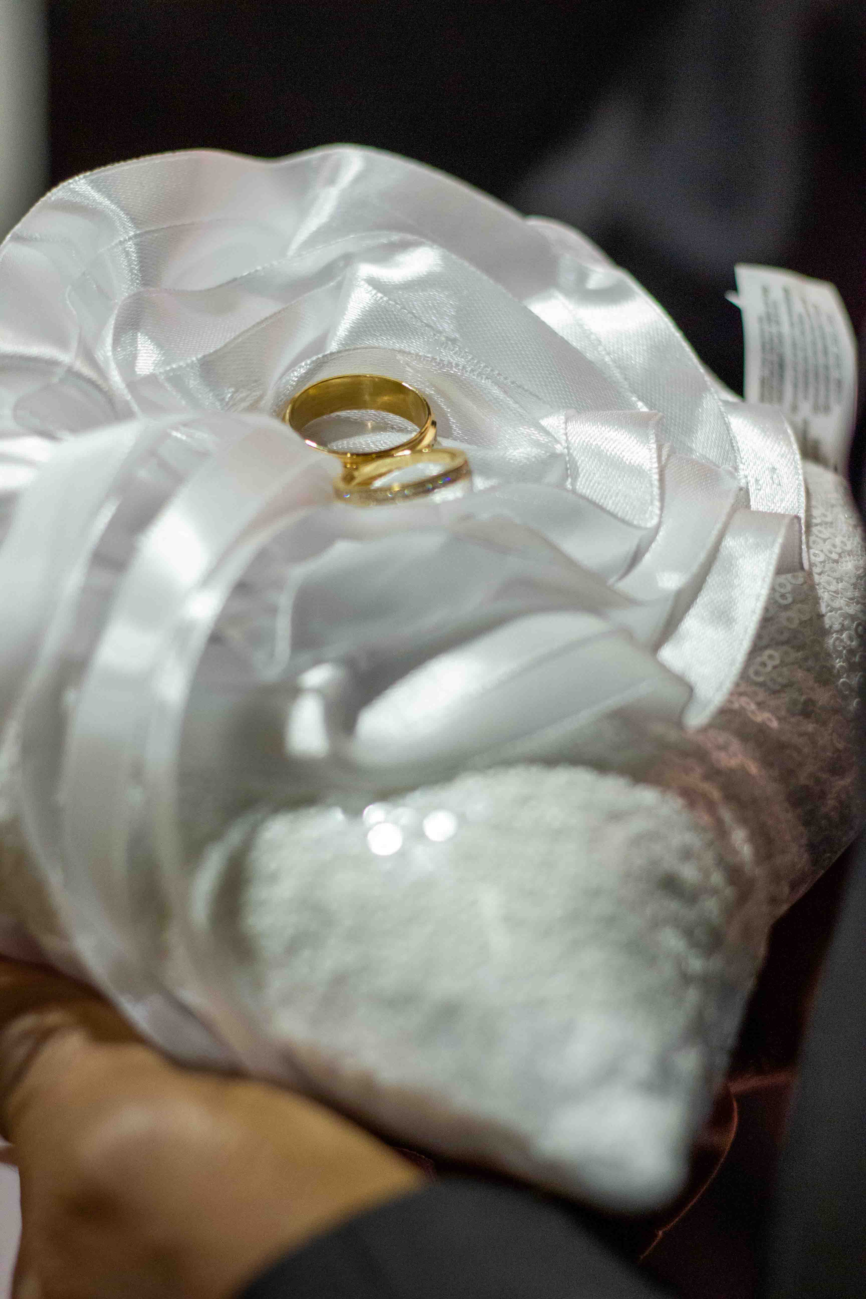 Wedding Videography and photography of rwedding bands/rings on a pillow
